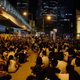Over a thousand protesters listen to a 14-year-old secondary school student speaking on a podium, shown on a screen, during a rally in Hong Kong September 26, 2014.